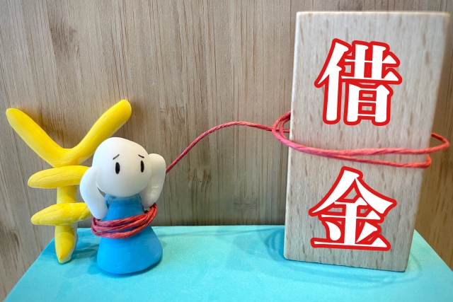 お金を手に頭を抱える。糸魚川市で債務整理の無料相談が弁護士にできます